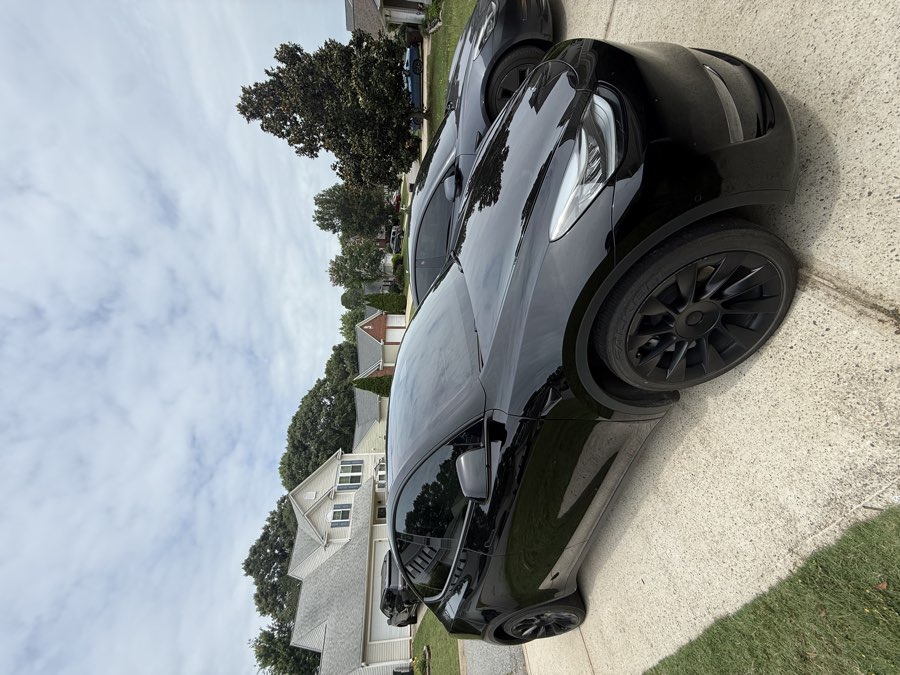 Dark tinted rear windows on a car, installed by Torque N Tint Co. in Greenville SC