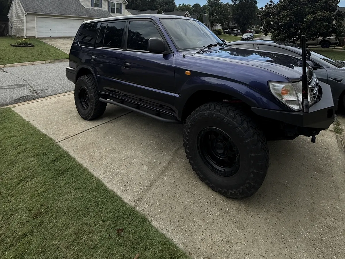 Lifted purple Toyota Land Cruiser with window tint